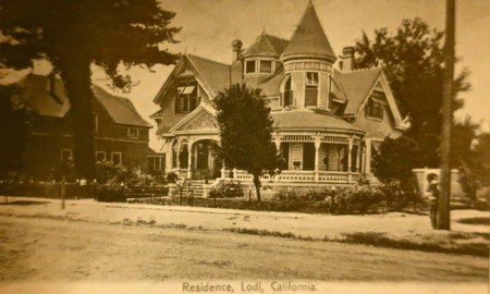 On a card postmarked in 1909, the landmark Hill House located across S. School St. from the U.S. Post Office; the Queen Anne Victorian style residence of George Washington and Mary Lewis Hill; later (in 1948) moved from Downtown Lodi to a neighborhood on S. Church St. where it is now an occasionally viewable museum.