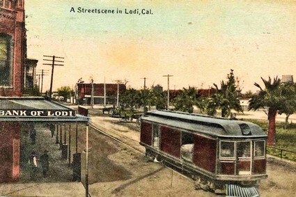 1915 postcard showing a Central California Traction Company electric streetcar on Lodi's Sacramento Rd. at the corner of Pine St.; a passenger service that once ran from the Port of Stockton to Sacramento.