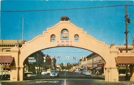 Lodi's Mission Arch during the late 1950s; the postcard's back-side proclaiming the region to be "The Home of the Flame Tokay Grape"