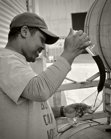 Klinker Brick winemaker Joseph Smith taking a taste of old vine Lodi Carignan from the barrel.